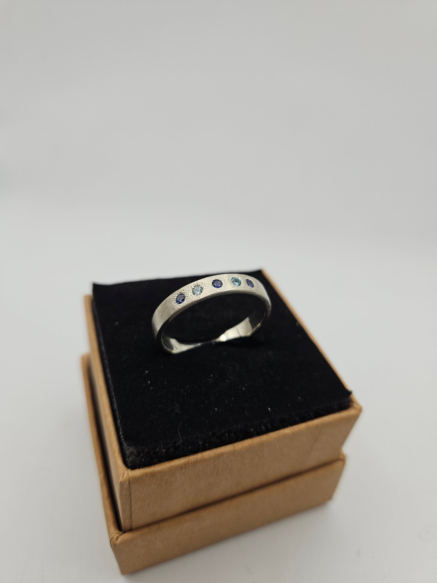 Hammered silver band with blue flush set CZ- Size U 3/4