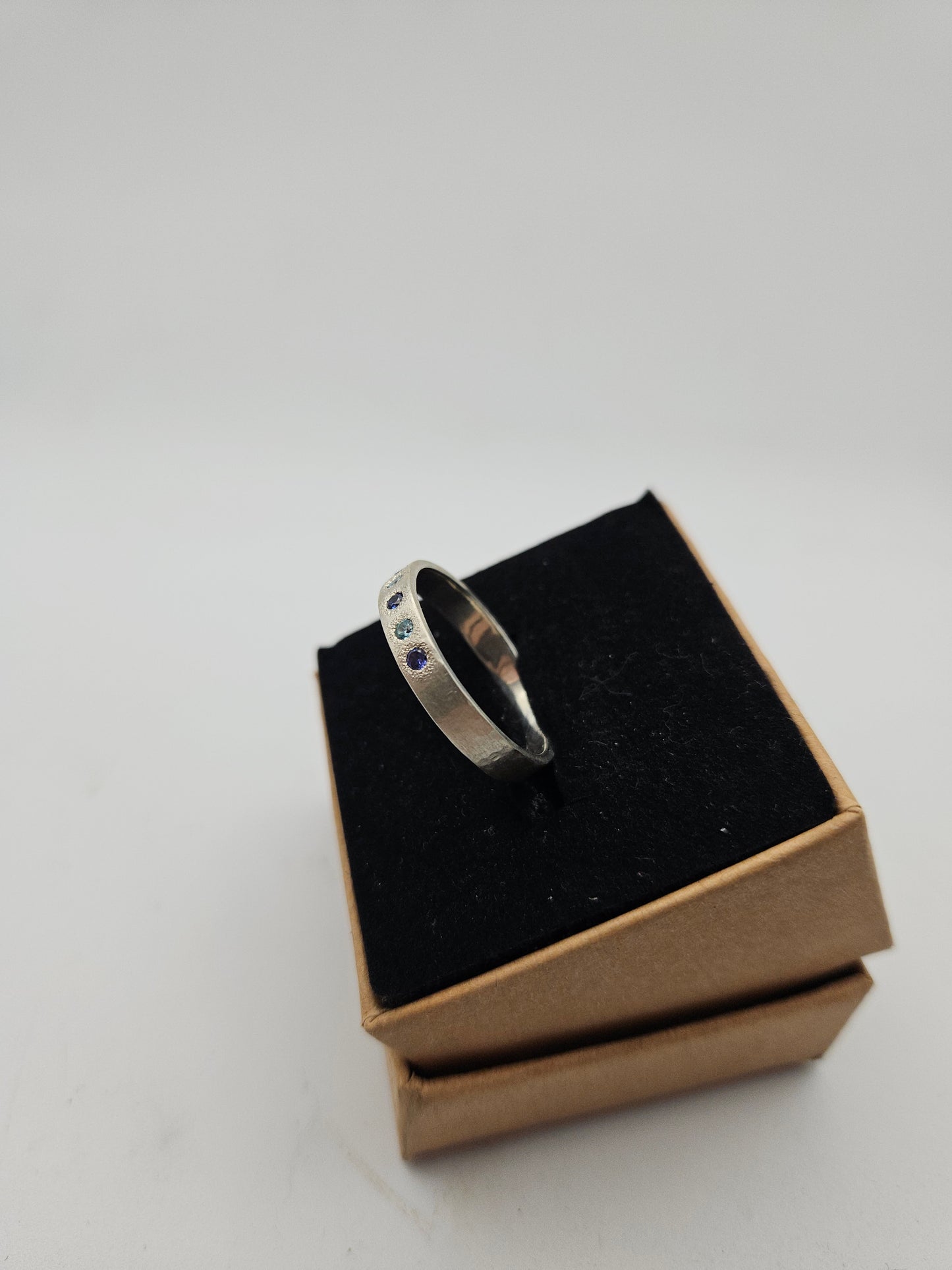 Hammered silver band with blue flush set CZ- Size U 3/4