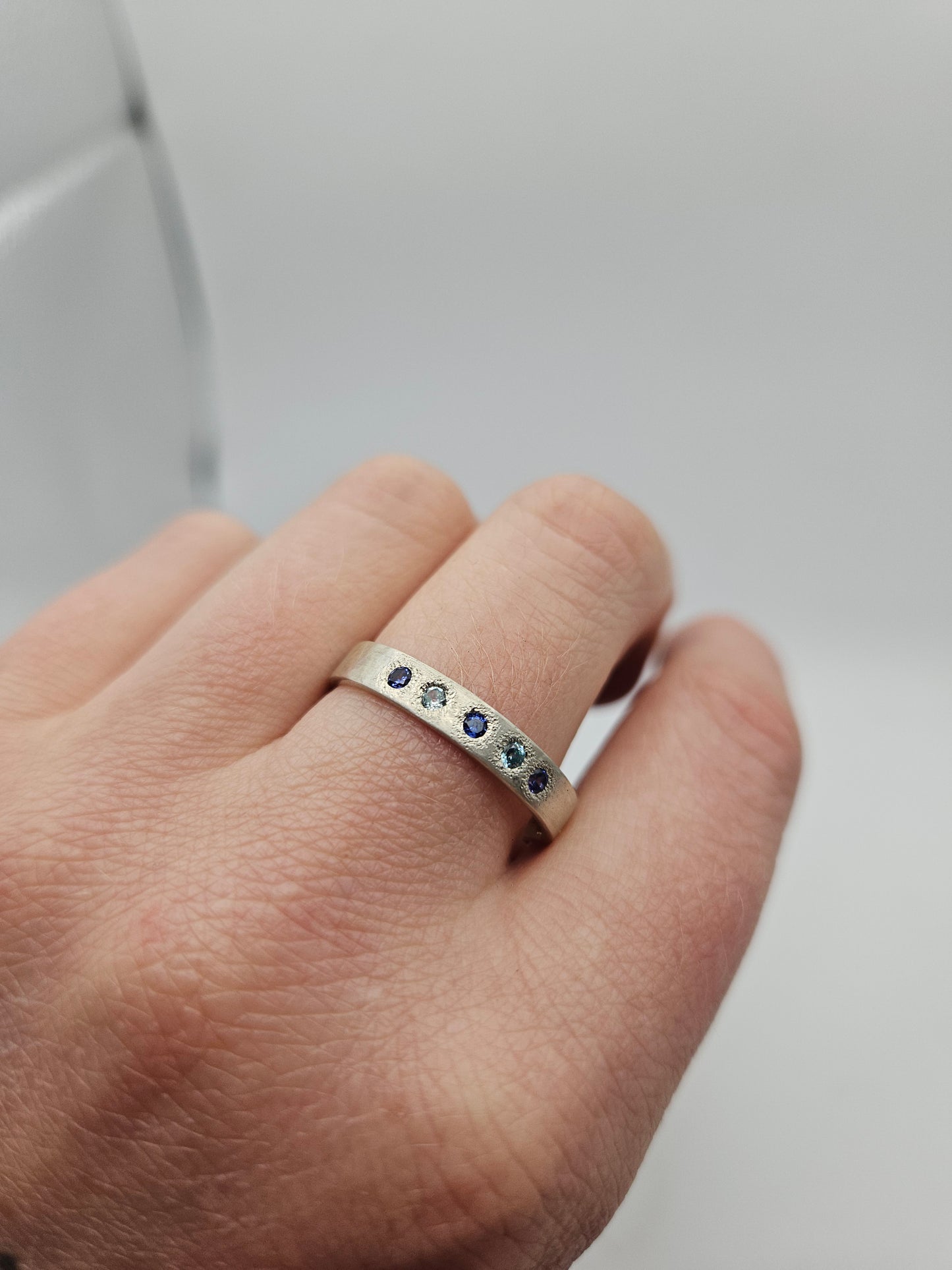 Hammered silver band with blue flush set CZ- Size U 3/4