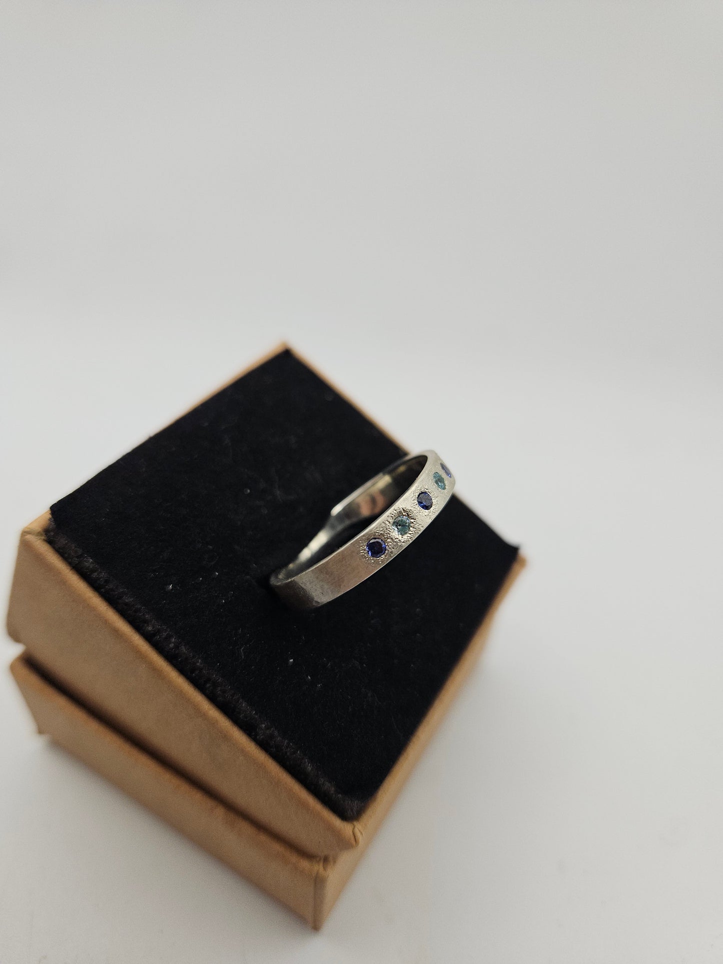 Hammered silver band with blue flush set CZ- Size U 3/4