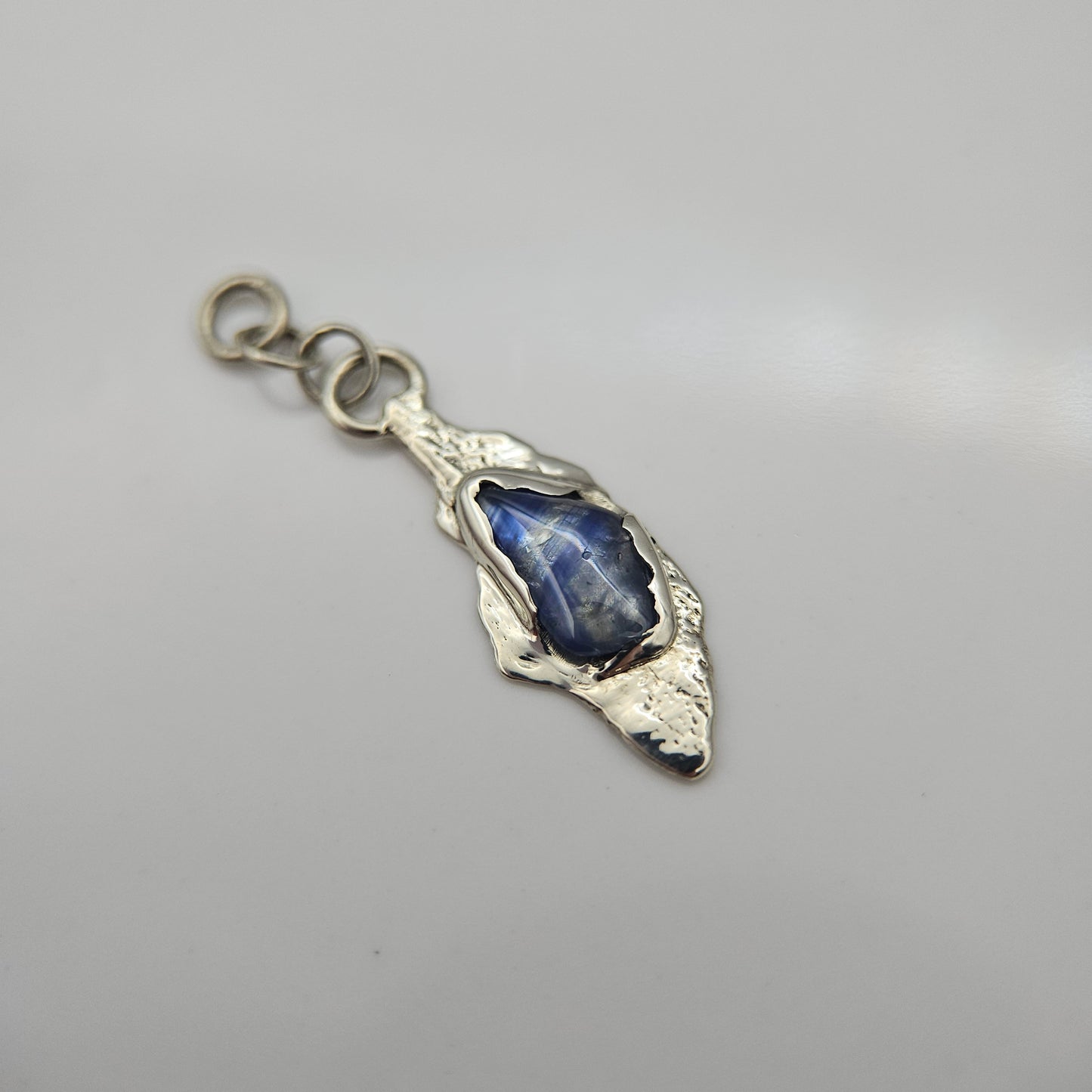 Blue striped Sapphire set in solid 9ct white gold  - Charm